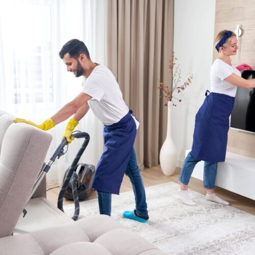 professional-cleaners-blue-uniform-washing-floor-wiping-dust-from-furniture-living-room-apartment-cleaning-service-concept